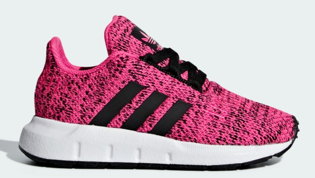 Pink kids shoe with black adidas stripes