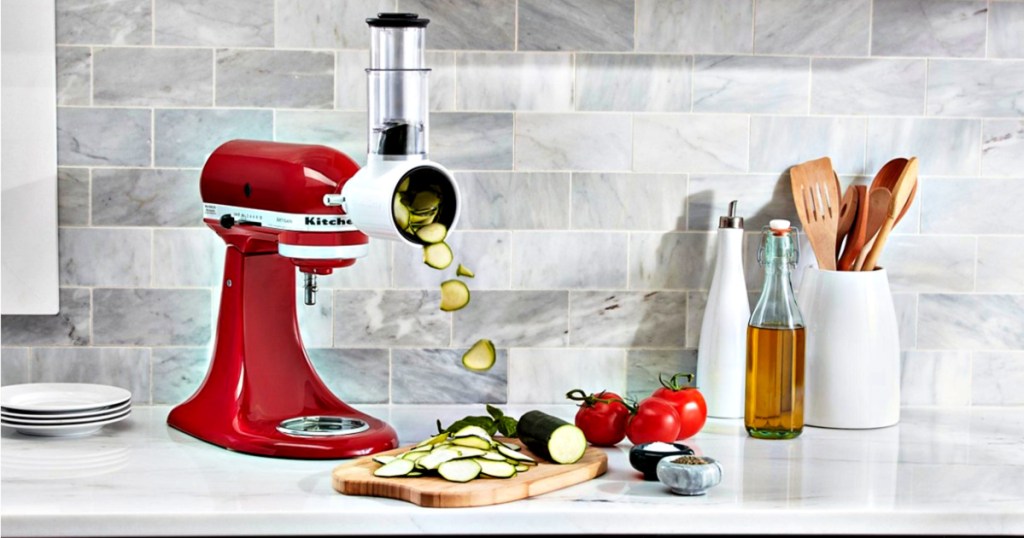 KitchenAid Artisan 5-Quart Tilt-Head Stand Mixer Value Bundle on counter slicing cucumbers