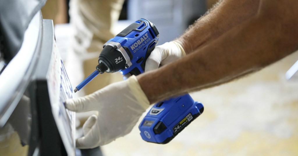 man using a Kobalt impact driver