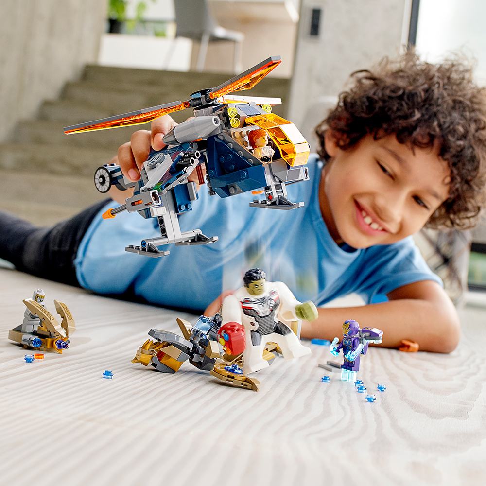 boy playing with LEGO Helicopter