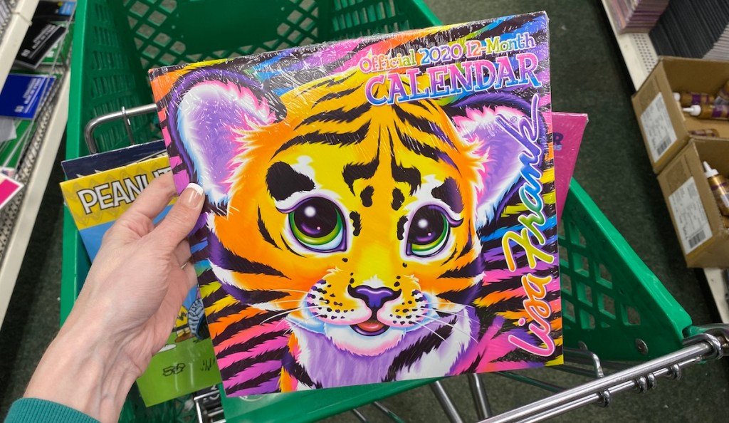 hand holding a Lisa Frank Calendar