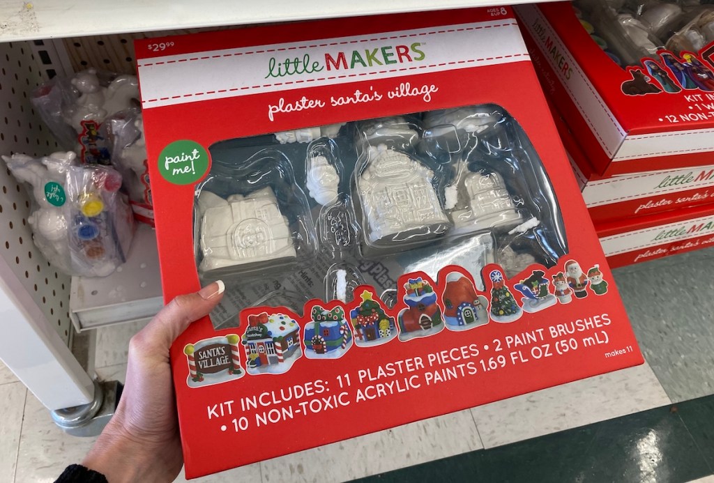 hand holding a Little Makers Plaster Santa's Village set