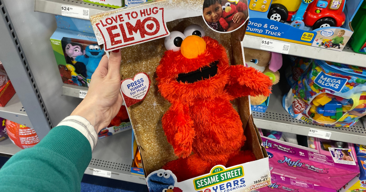 hand holding love to hug elmo in store