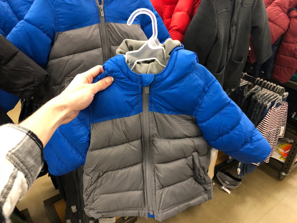 woman holding blue and grey Old Navy Frost Free Jacket in store