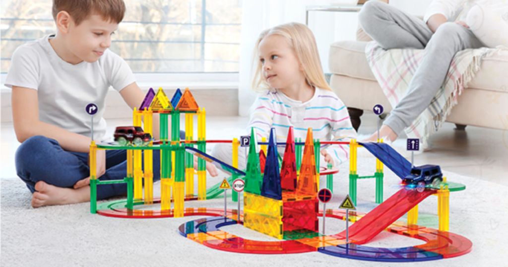 Kids playing with PicassoTiles Race Track 80-Piece Magnetic Building Block Set in living room