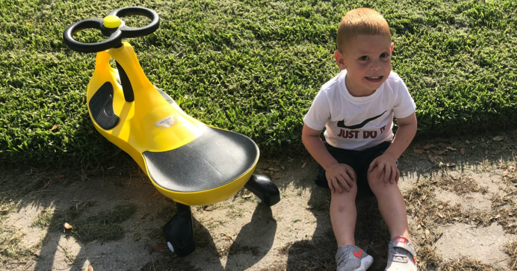 little boy next to a Plasma Car