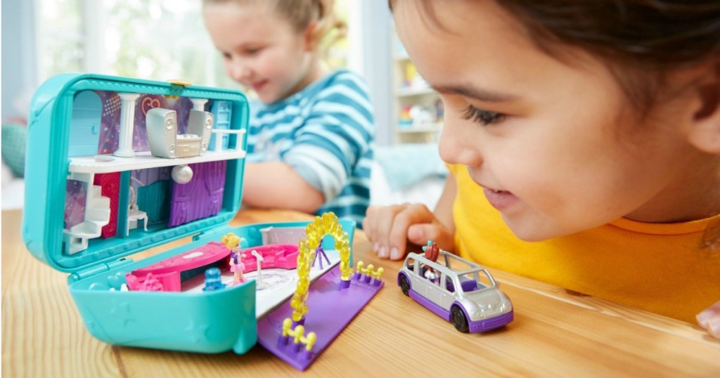 Girl playing with Polly Pocket Hidden Party Set