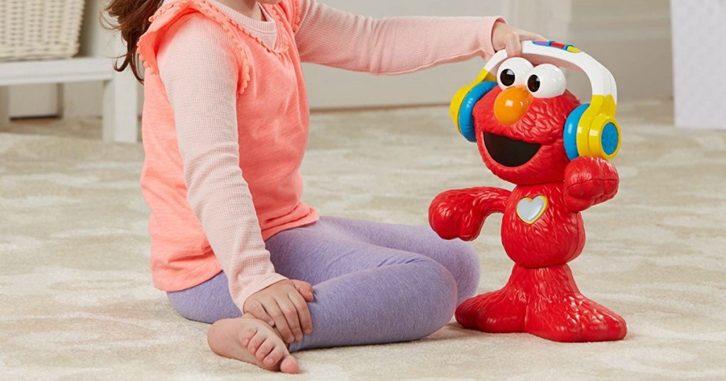 girl playing with Sesame Street Let's Dance Elmo