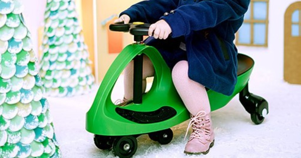 little kid riding joybay with christmas decorations