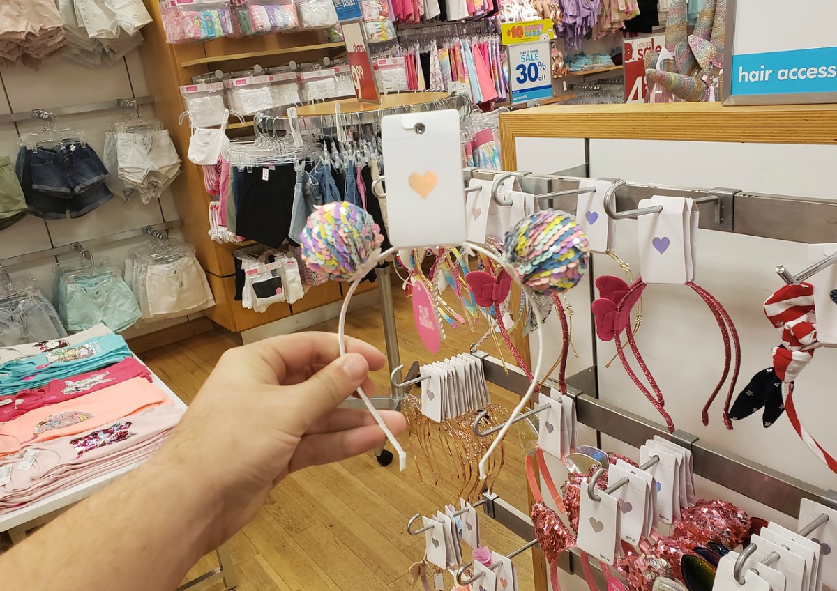 woman holding The Children's Place headband