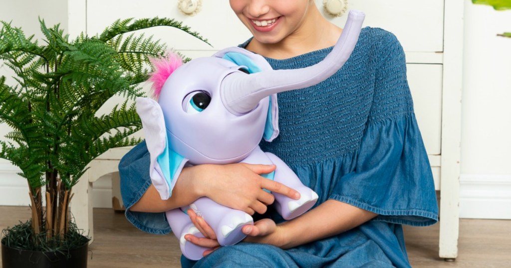 Girl holding Wildluvs Juno My Baby Elephant Electronic Pet