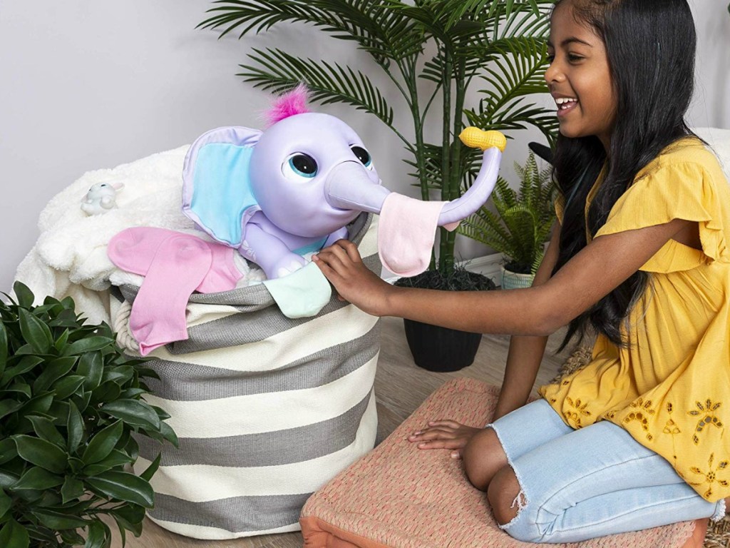 Girl playing with Wildluvs Juno My Baby Elephant Electronic Pet