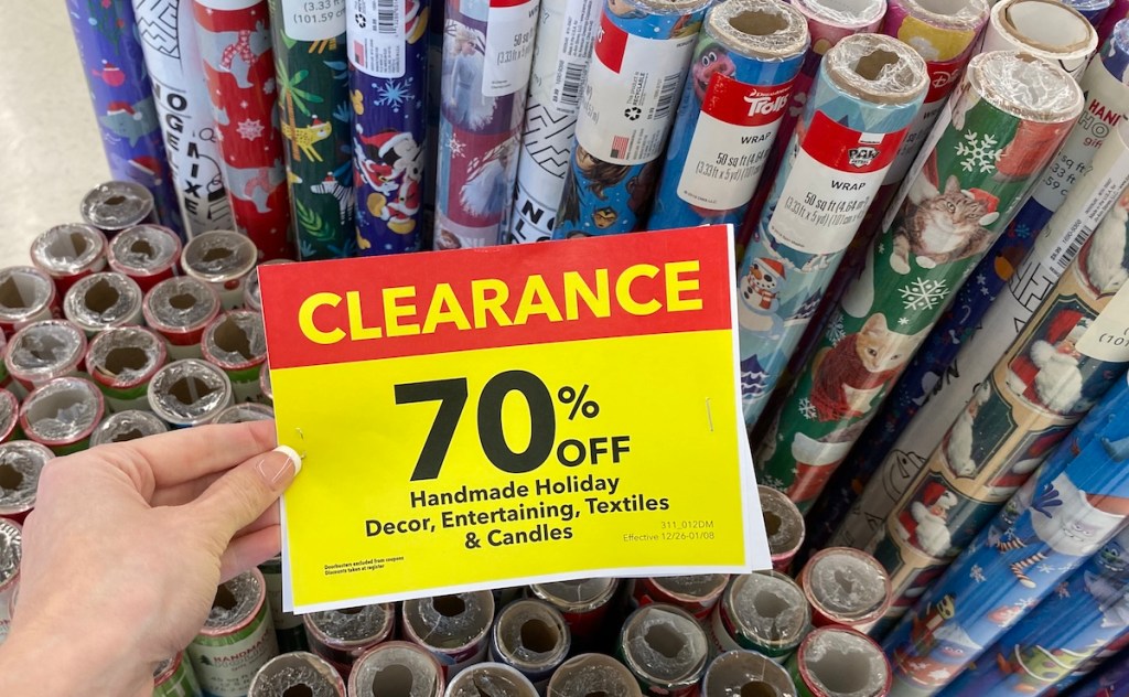 hand holding a sign by Wrapping Paper at JOANN