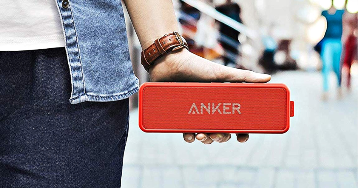 hand holding red anker bluetooth speaker