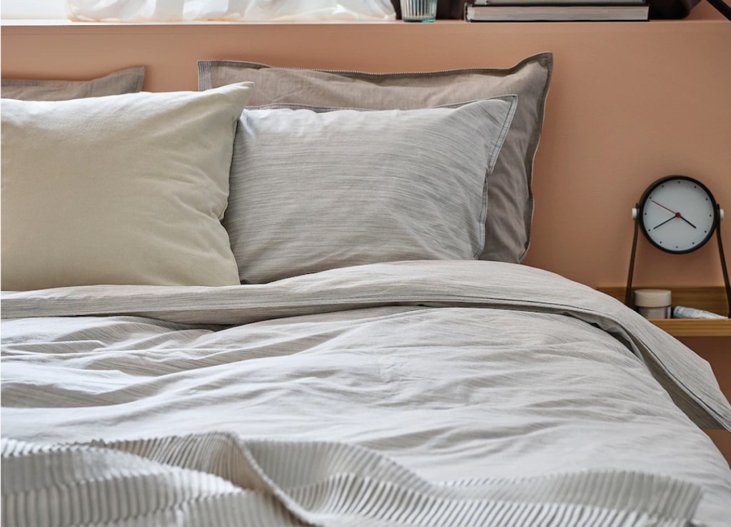 bedroom with beige and yellow bedding and orange walls