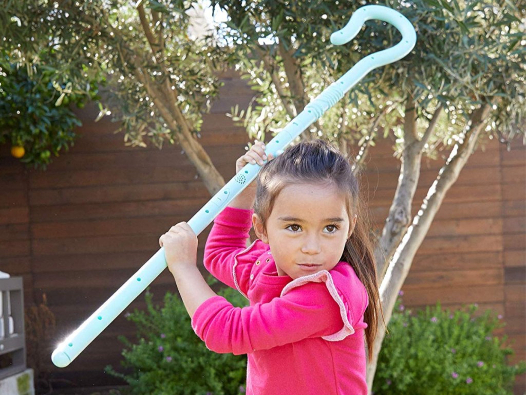 girl playing with bo peep staff