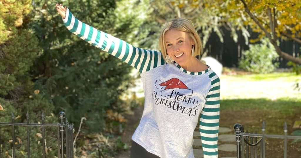 A woman in a Christmas shirt outside