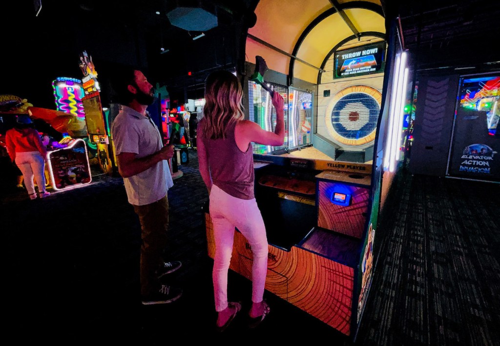 couple playing axe throwing game at Dave and Busters