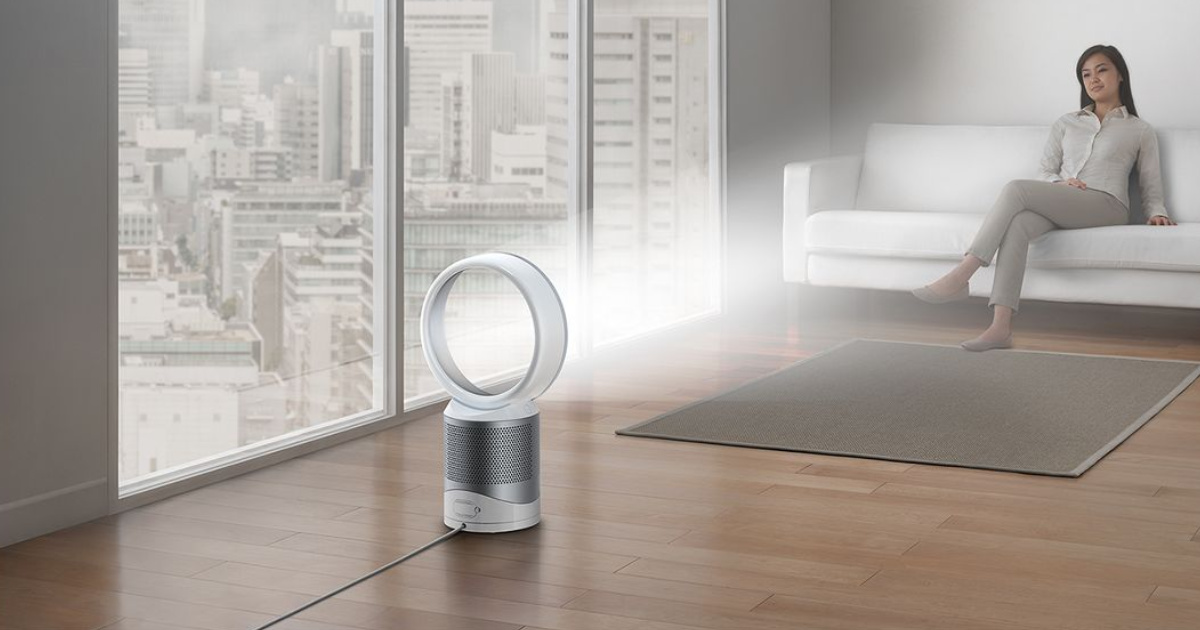 air purifier in living room with woman sitting on couch