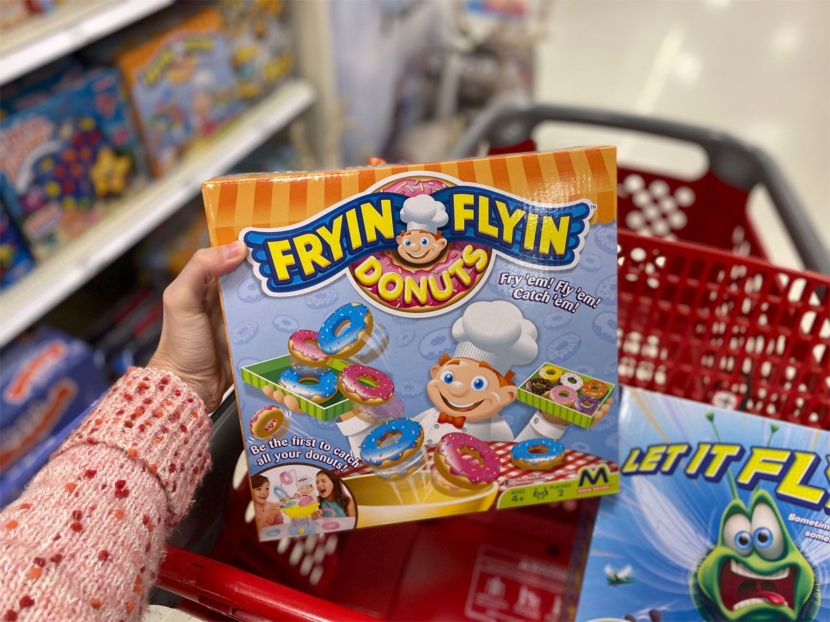 hand holding a maya game of frying flying donuts in a target shopping cart