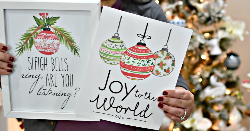 holding free printable christmas prints