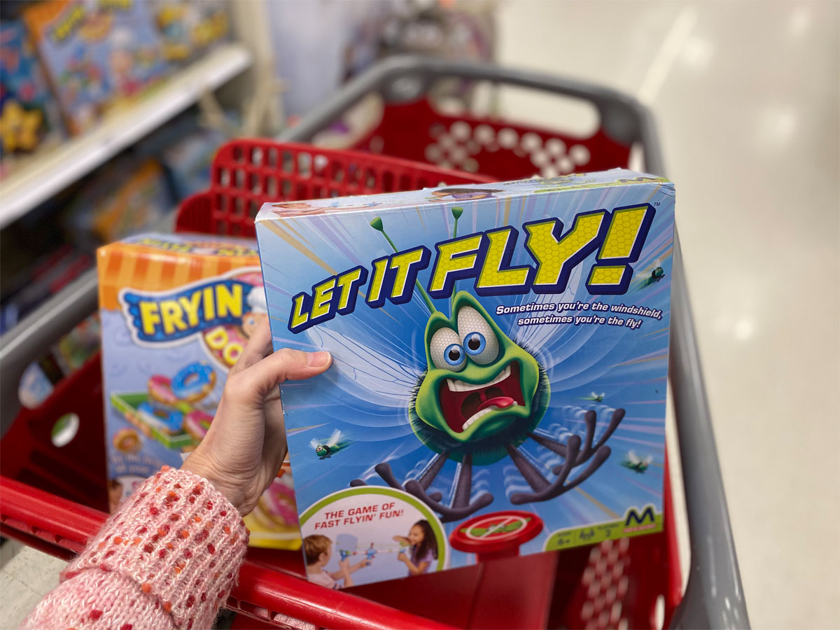 hand holding a maya game of let it fly in a target shopping cart