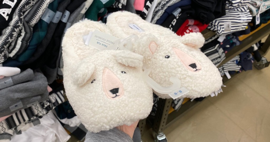 hand holding sherpa slippers in store