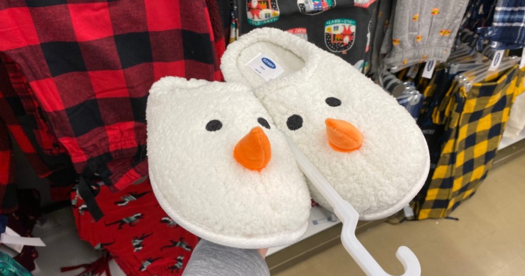 hand holding snowman slippers up in store