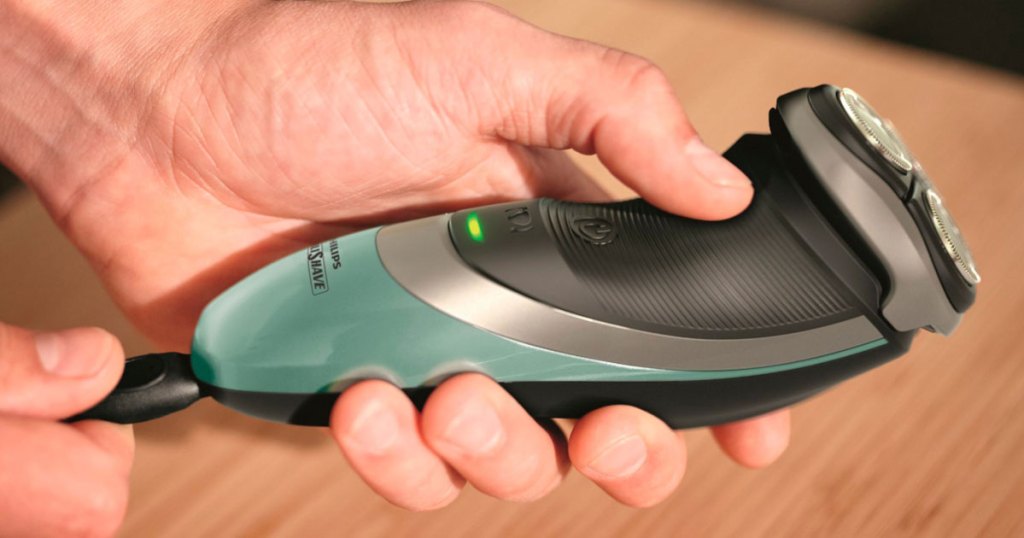 hand holding a Philips Norelco Philishave Electric Shaver