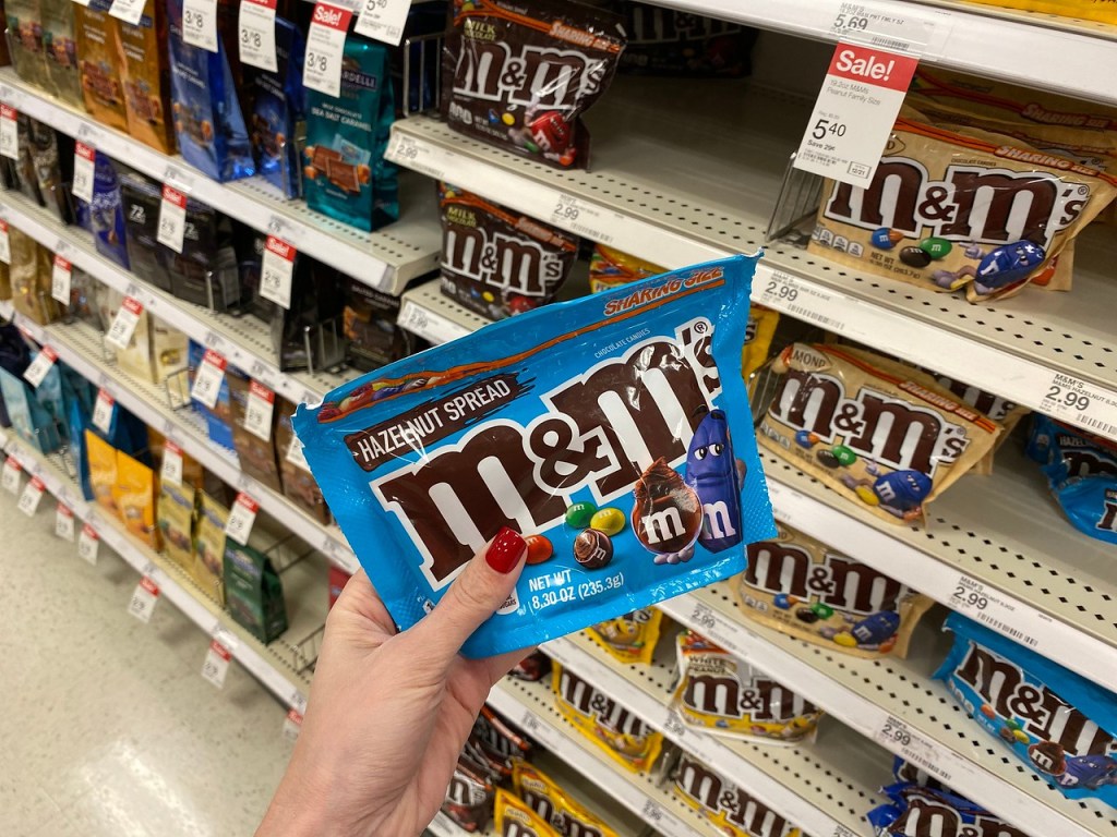 Hand holding Hazelnut M&Ms at Target 