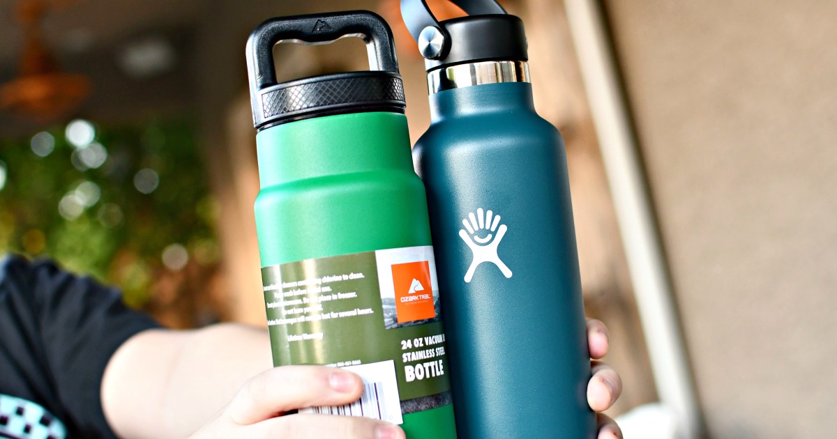 person holding an Ozark Trail and Hydro Flask water bottles 