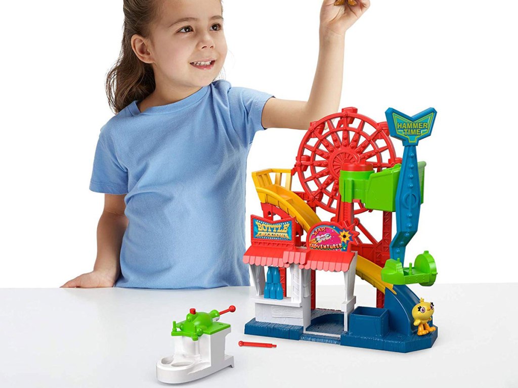 young girl playing with Toy Story Fisher-Price Disney Pixar 4 Carnival Playset