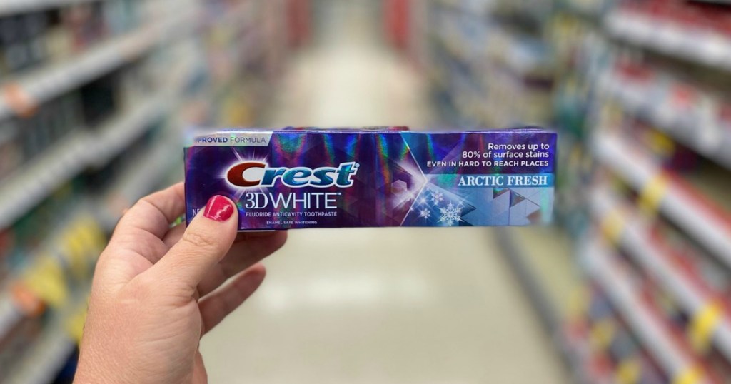 hand holding toothpaste in a store