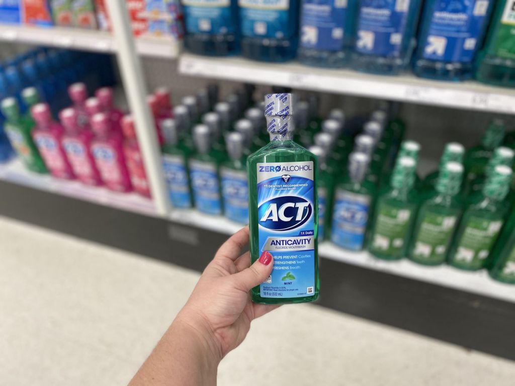 hand holding Act Zero Alcohol Mouthwash 18oz