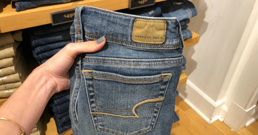 Pair of women's jeans in hand at American Eagle