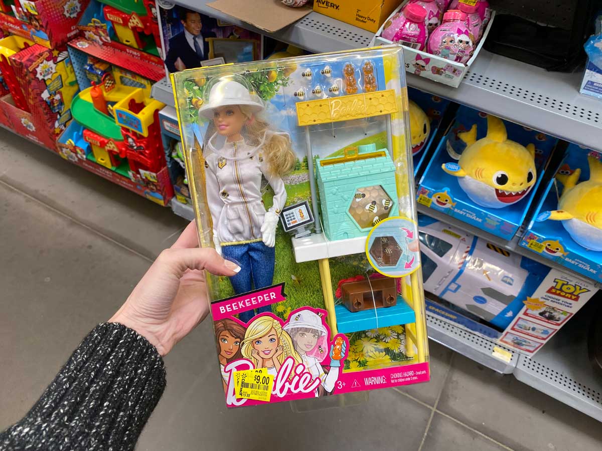 hand holding a Barbie Beekeeper doll