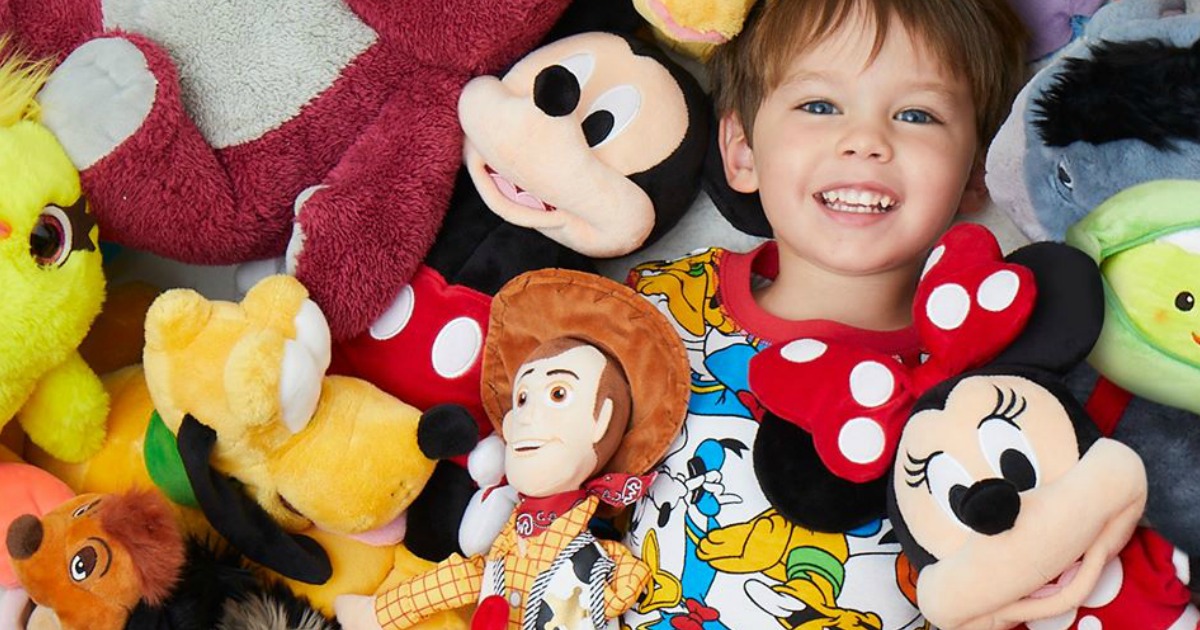 boy surrounded by Disney Plush