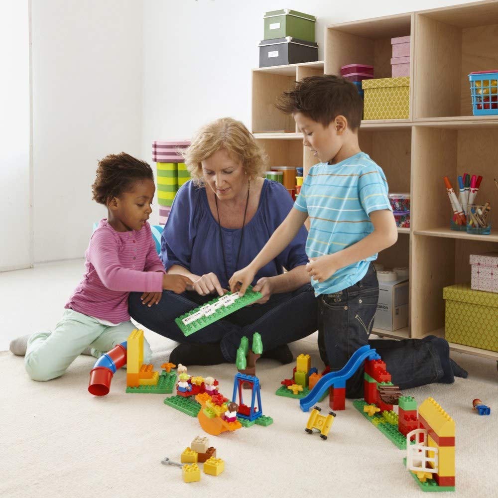 Teacher and kids playing with LEGO Duplo Playground