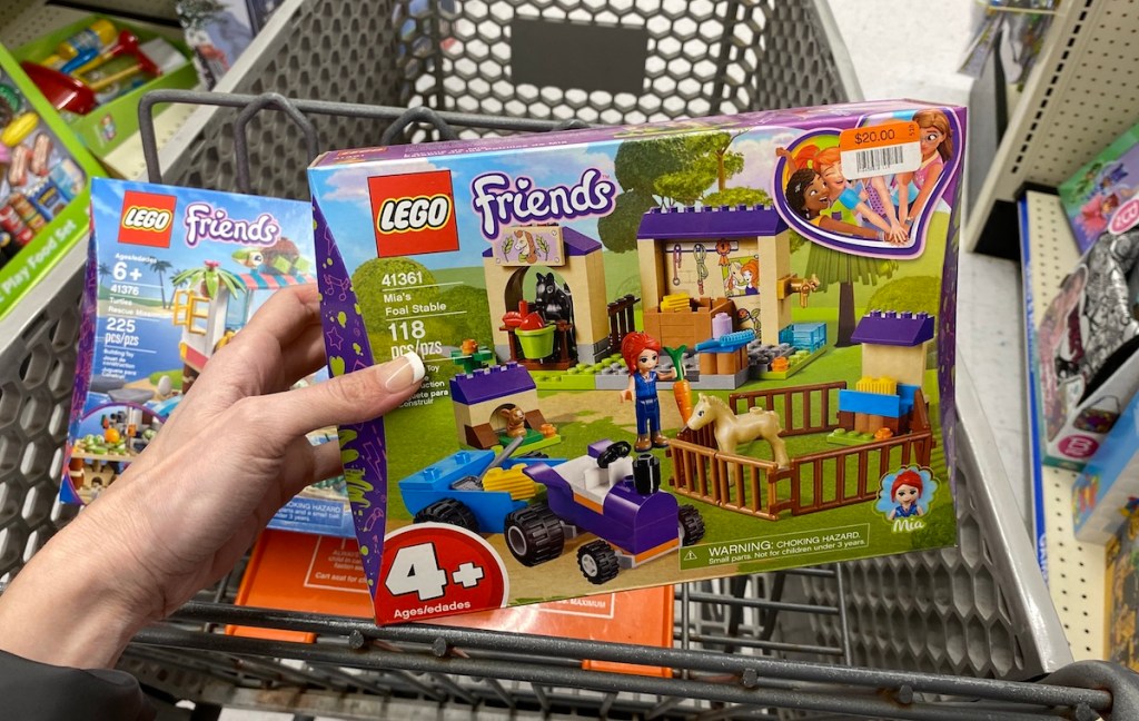 hand holding LEGO Friends Mia's Foal Stable in BIg Lots cart