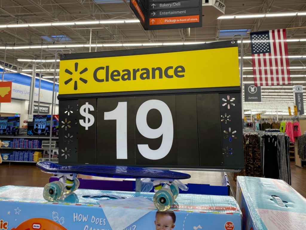 Walmart clearance sign for 19 dollars above a garden themed toy box