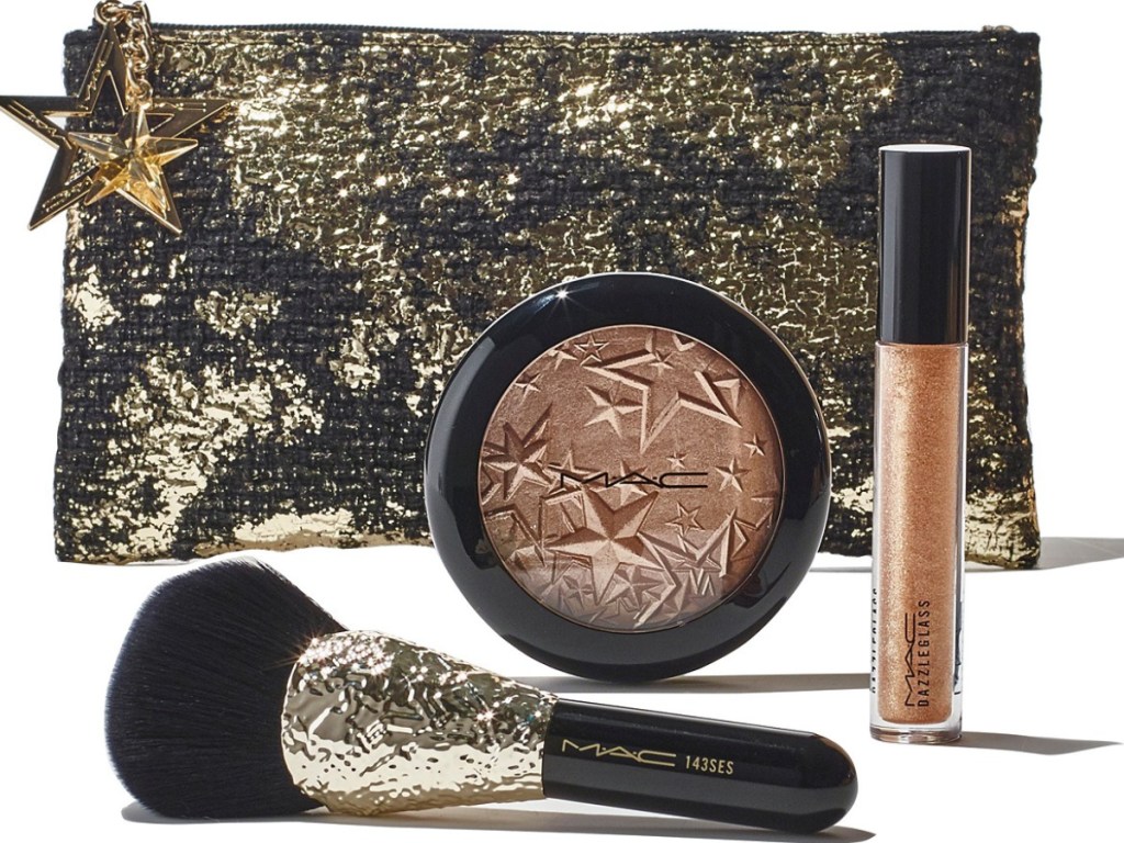 gold bag with mac bronzer, brush, and lip gloss outside bag