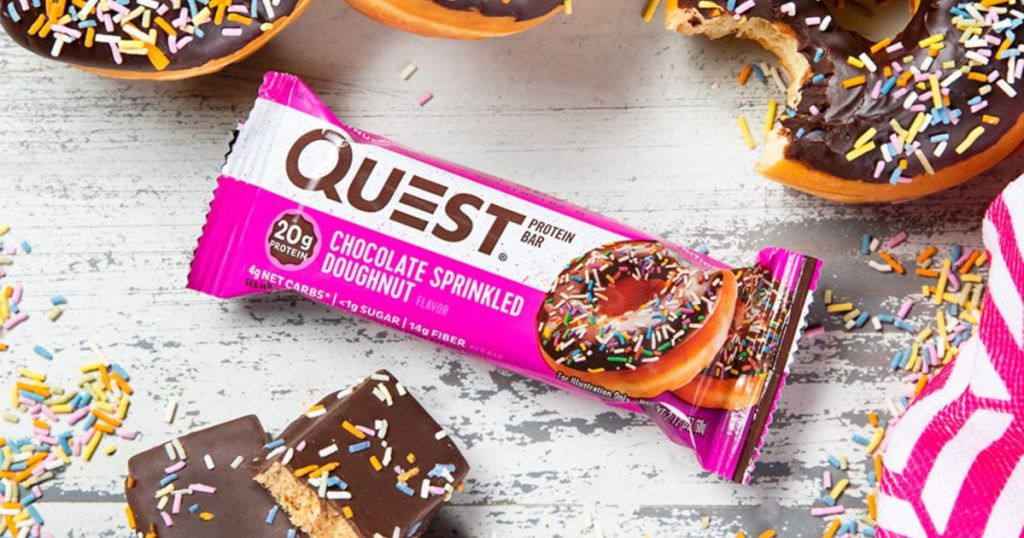 Quest Chocolate Sprinkled Doughnut Protein Bar with multiple chocolate doughnuts displayed