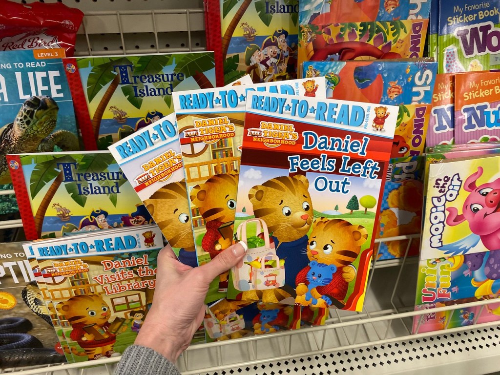 Woman Holding Ready to Read Books at Dollar Tree