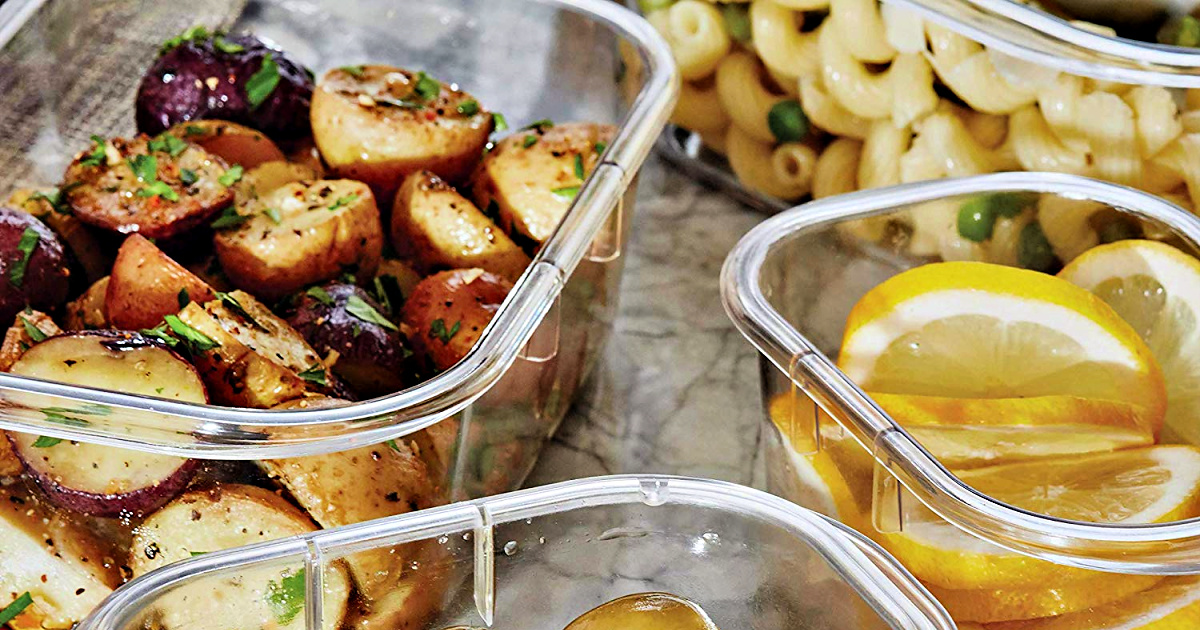 plastic food storage containers with veggies, pasta, and lemons