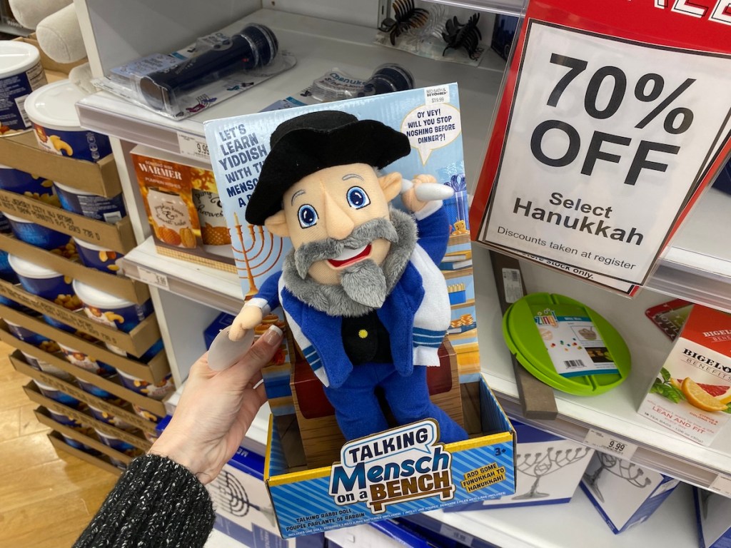 hand holding a Talking Mensch on a Bench