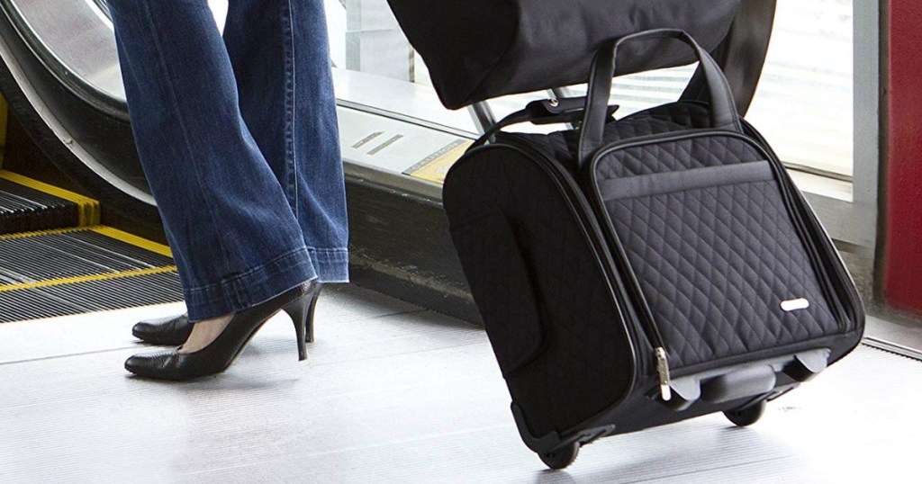 Woman walking with a wheeled carry on bag