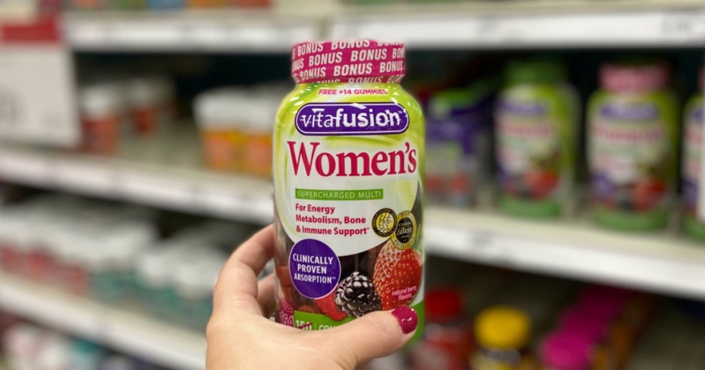 Woman holding Vitafusion Women's Gummies