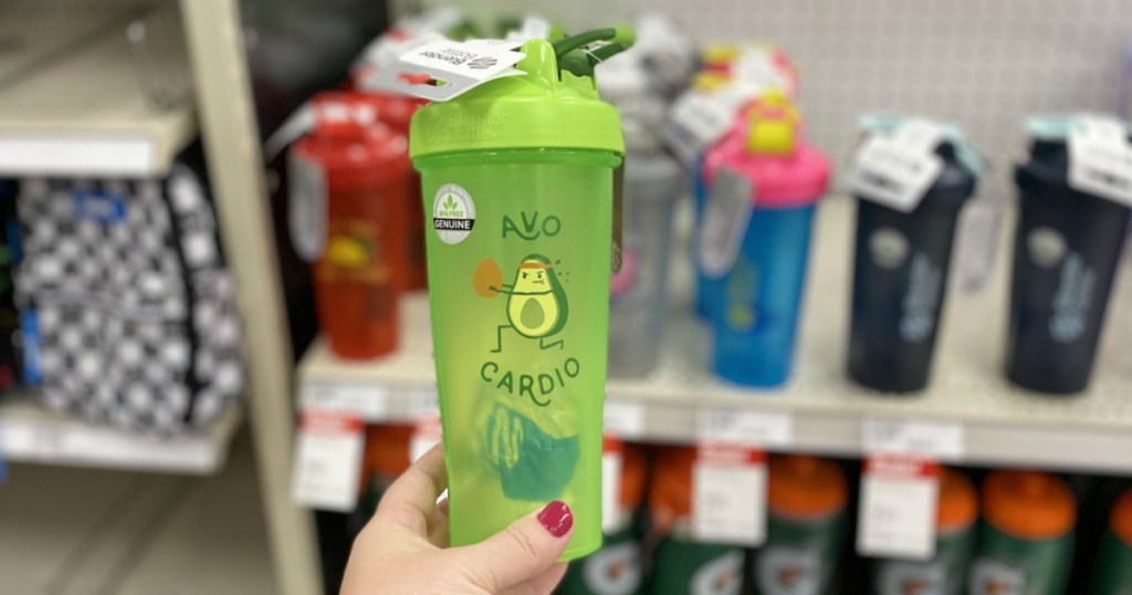 green cup with exercising avocado held in store