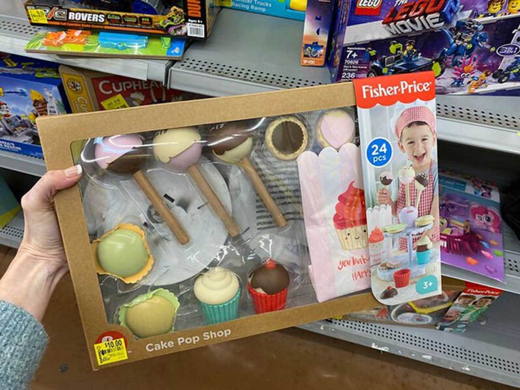 hand holding fisher price cake pop shop