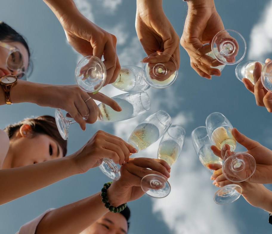 group of people doing a cheers with sky above wedding ideas on a budget